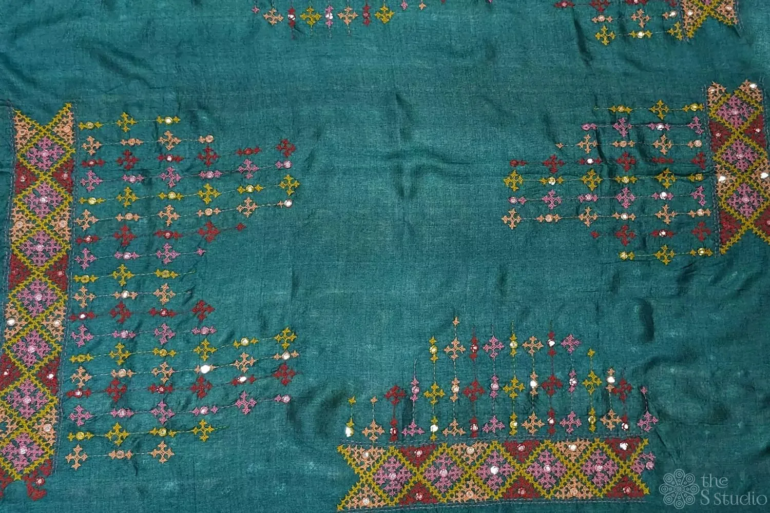Dark green tussar silk material featuring mirror work kutch hand embroidery